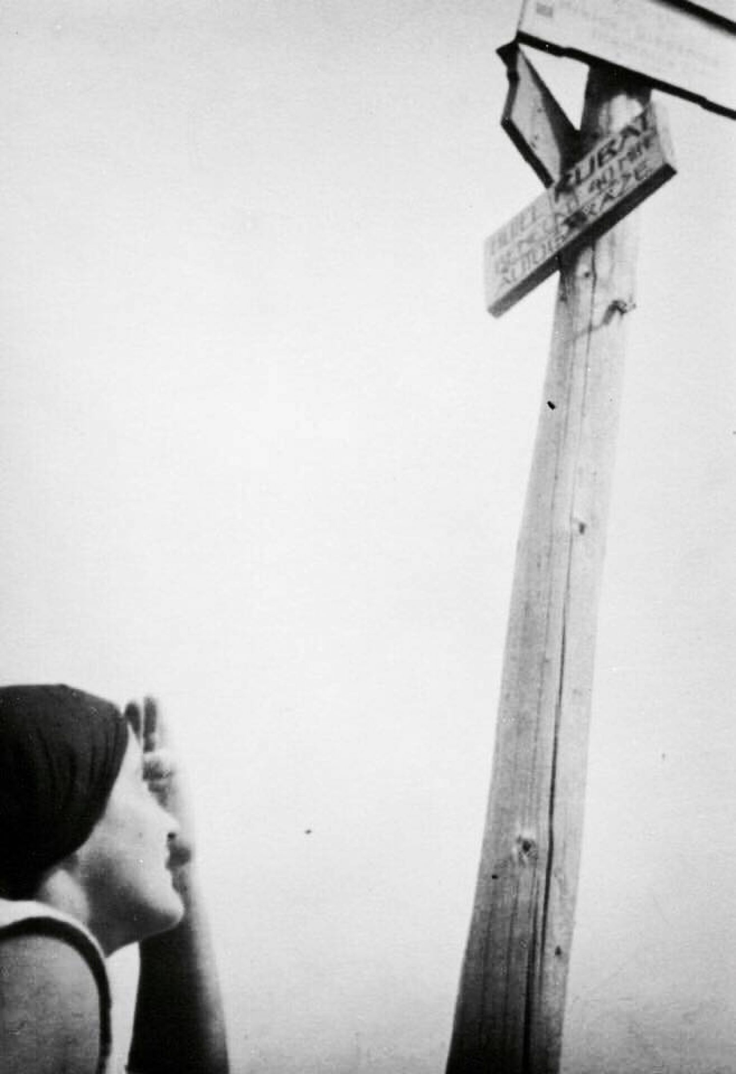 Josef Bartuska, «Untitled (Woman looking up at signs)», 1930